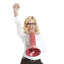 A blonde woman who is holding a red megaphone